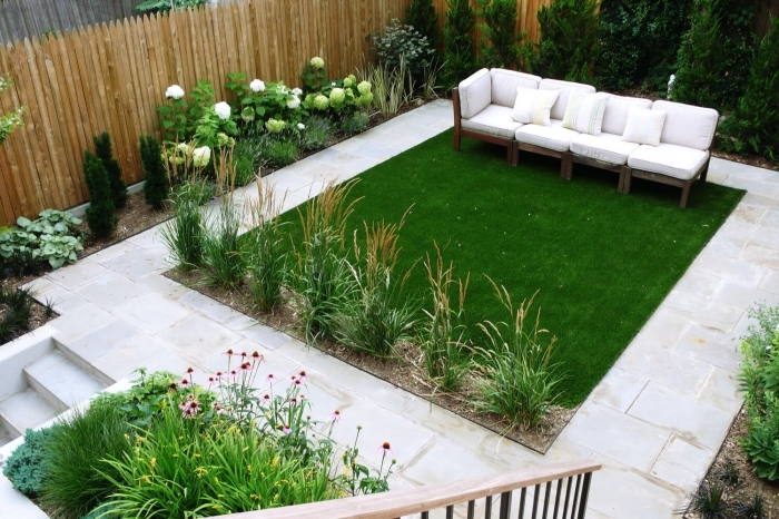 idée déco de cour arrière avec pelouse et floraisons, modèle de banc en bois brut pour le jardin, escalier bois et fer extérieur