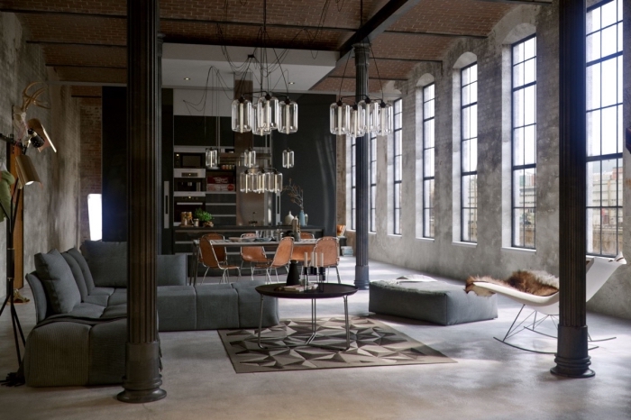 aménagment loft industriel aux murs béton avec canapé gris anthracite et petite table métal, idée chaise style industriel