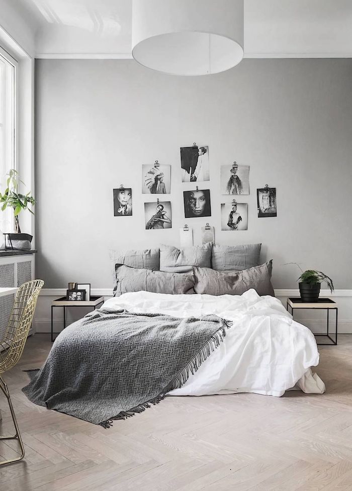 Chambre gris avec galerie de photos sur le mur, lit sans tête, coussins décoratifs, lit avec rangement, astuce rangement chambre, belle chambre à coucher