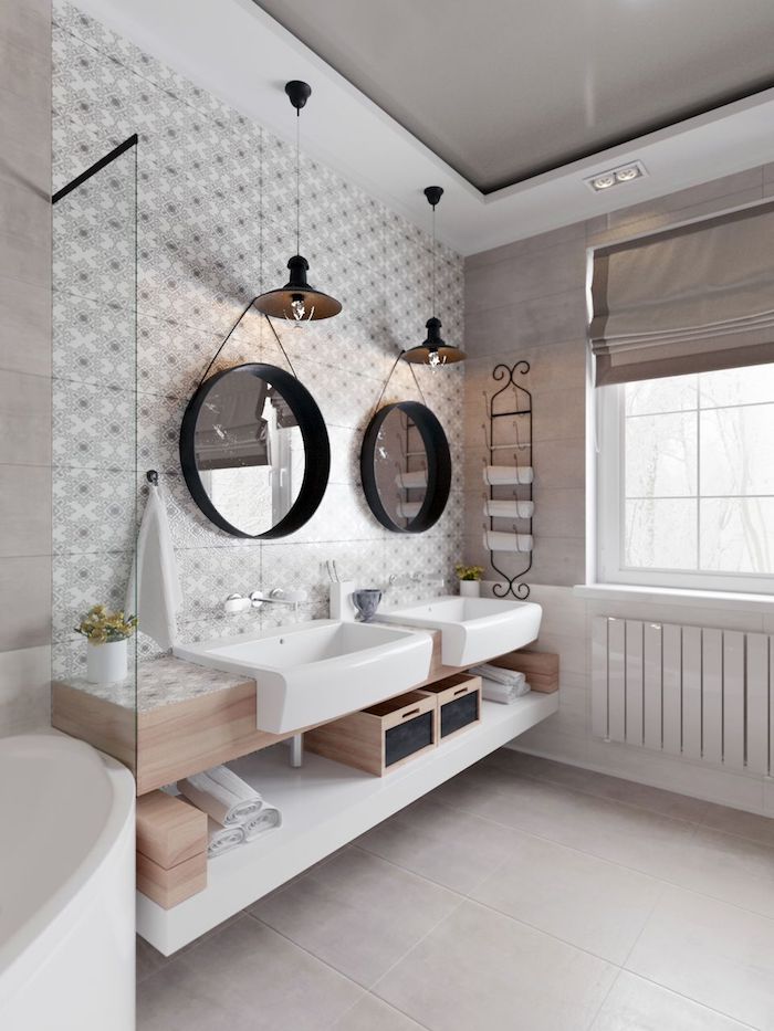 Deux miroirs rondes, carrelage à motif, boites rangement, tendance salle de bain en bois et blanc moderne au style scandinave