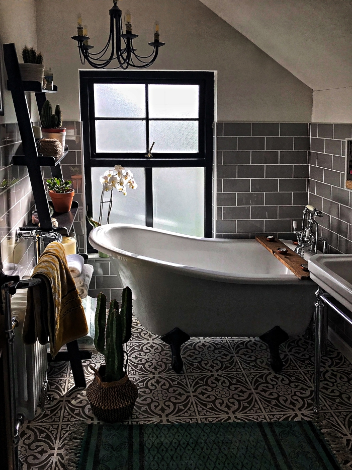 idee salle de bain petite surface aménagée sous les combles avec baignoire sur pieds vintage et une étagère échelle décorée de mini-pots de plantes