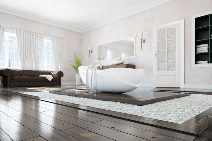Magnifique salle de bain blanche avec détails brunes et pierres sur le sol pour déco zen, salle de bain zen calme et bien rangée