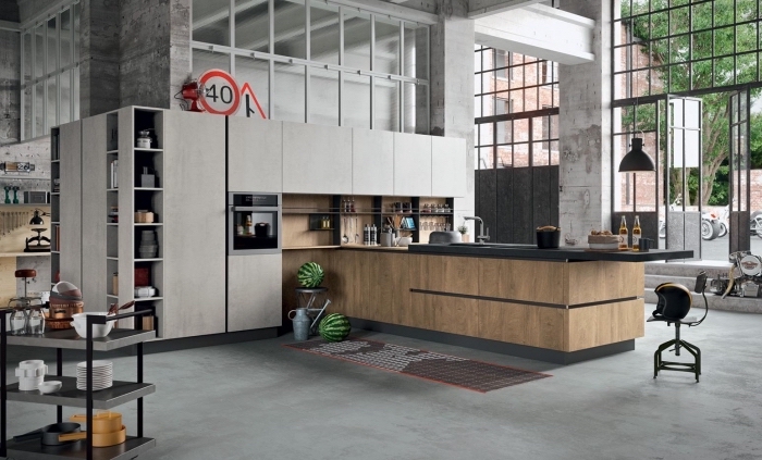 modèle de cuisine industrielle aux murs et plancher béton, meubles de cuisine en bois blanc avec crédence bois