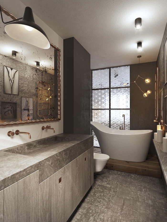 comment aménager une salle de bain moderne aux murs gris avec plancher effet béton, exemple évier béton avec robinet cuivre
