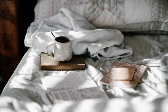 wallpaper pc avec cadre cozy d'un lit cocooning avec tasse de café et livres, exemple de fond d écran gratuit
