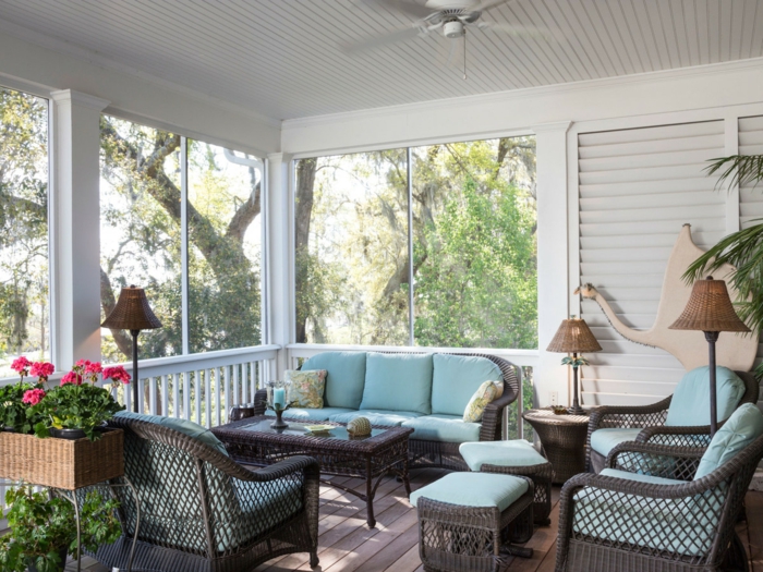 veranda ouverte en bleu et blanc, jardinière avec plante fleurie, lampes abat-jours