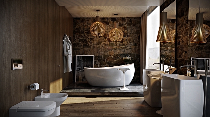 salle de bain de luxe où dominent les matériaux naturels avec baignoire zen sur podium en béton mis en valeur par un mur en pierre naturelle
