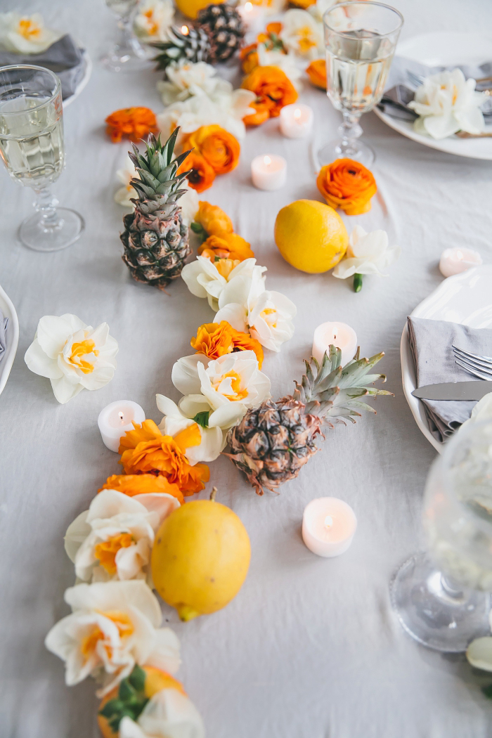 décoration de table de fete, fleurs oranges et blanches, nappe gris clair, serviettes grises