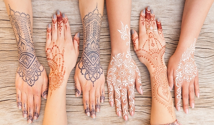 photo de henné de différentes couleurs à design ethnique, modèle de henné rouge naturelle aux motifs mandala