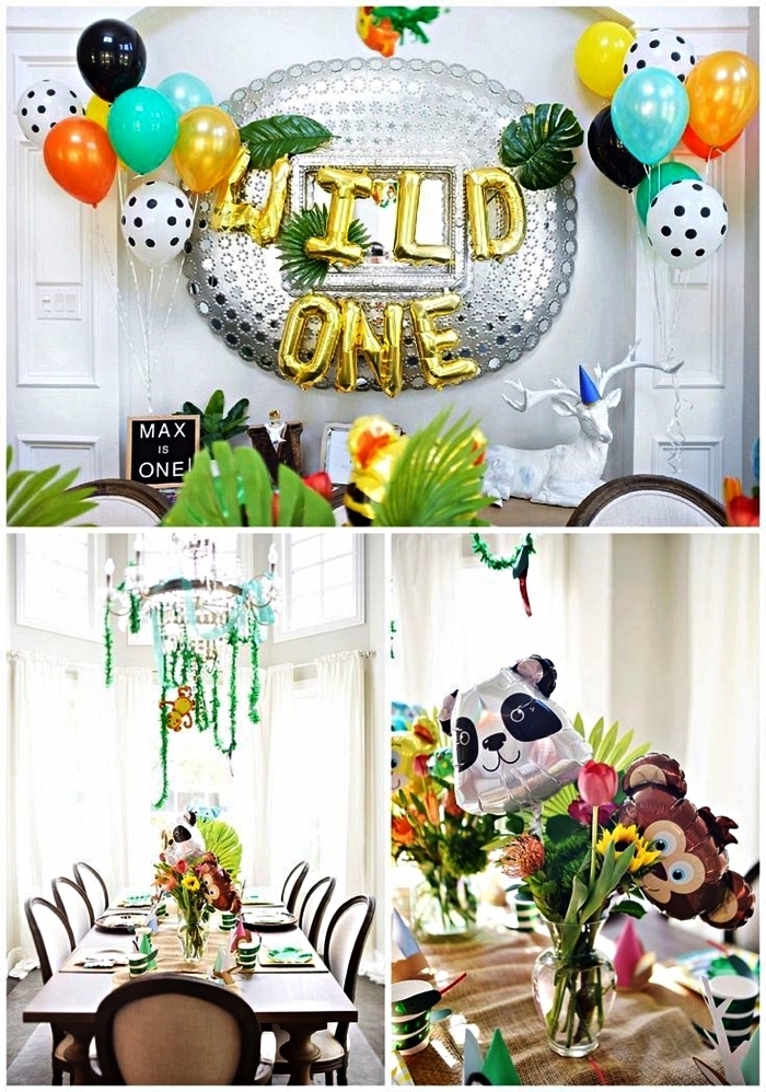 décoration anniversaire 1 an sur le thème jungle avec ballons et feuilles tropicales artificielles, déco de table avec ballons animaux de la jungle et bouquets de fleurs