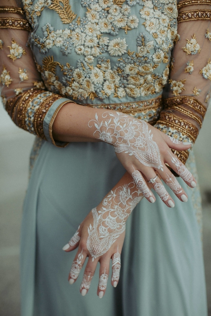 modele henné pour mariage, idée tatouage temporaire aux motifs floraux et feuilles, exemple dessin blanc sur main