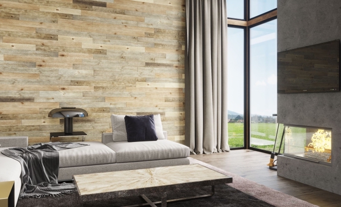 design intérieur moderne dans une pièce avec cheminée béton et murs habillées en planches de bois différentes couleurs