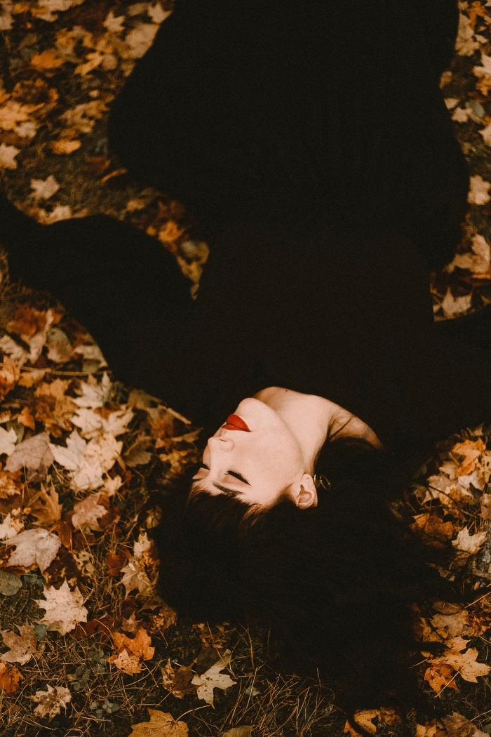fille-maquillage-rouge-à-lèvre-robe-noire-déguisement-hallowen-en-sourcière-image-halloween-nature-feuilles-séchées idée déguisement femme en sorcière pour la fête de halloween, écran verrouillage avec photo femme sur arbres séchées pour halloween 2019