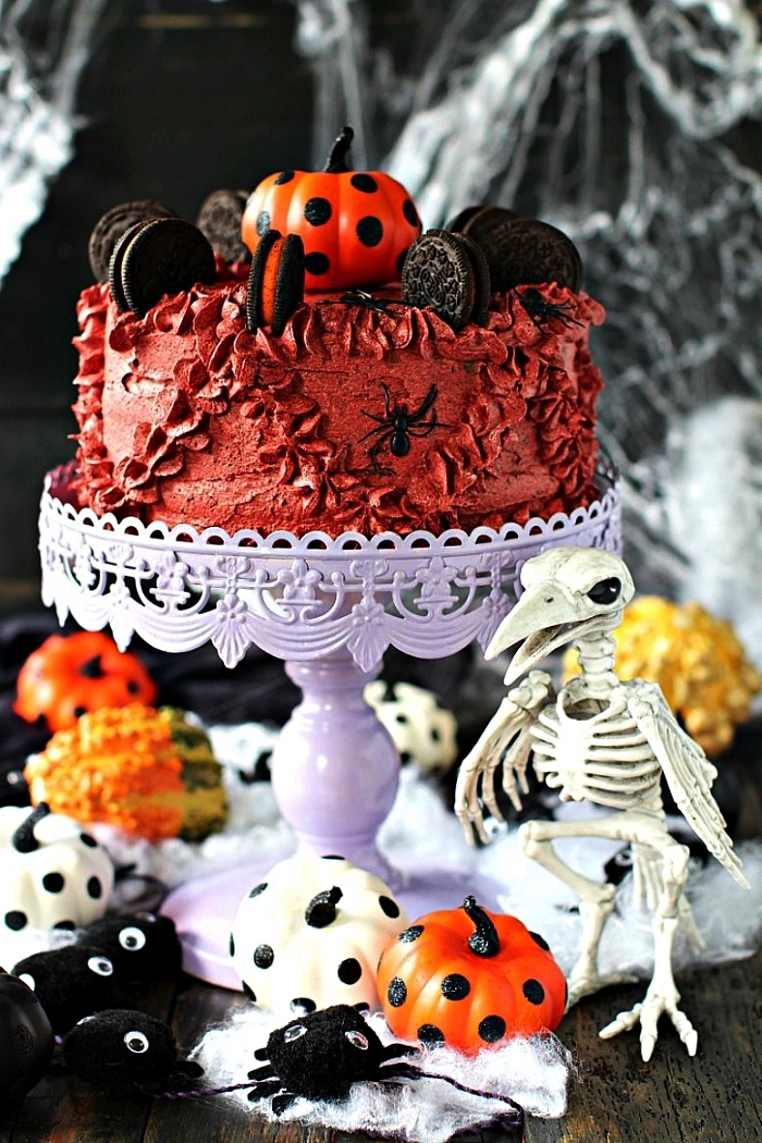 gateau d'halloween au glaçage crème beurre rouge, décoré de biscuits oreo et d'une citrouille décorative