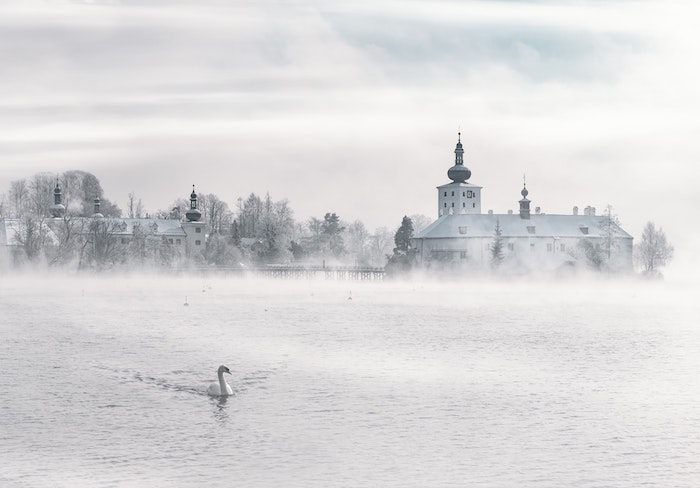 beau paysage d une ville aux églises dans une brume et lac, fond d écran hiver romantique et énigmatique