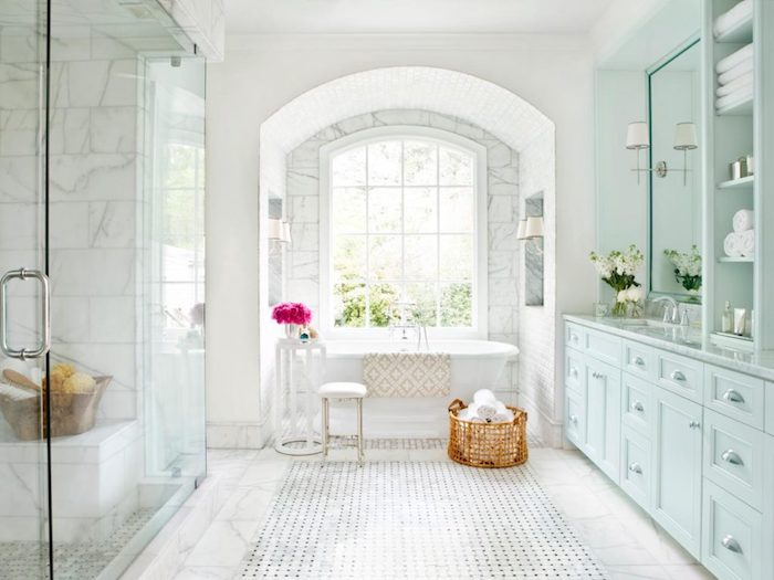 Arche de fenêtre qui donne de lumière de jour, vase avec fleurs, meuble de rangement bleu claire, modele salle de bain, idée stylée salle d'eau et cabinet de toilette