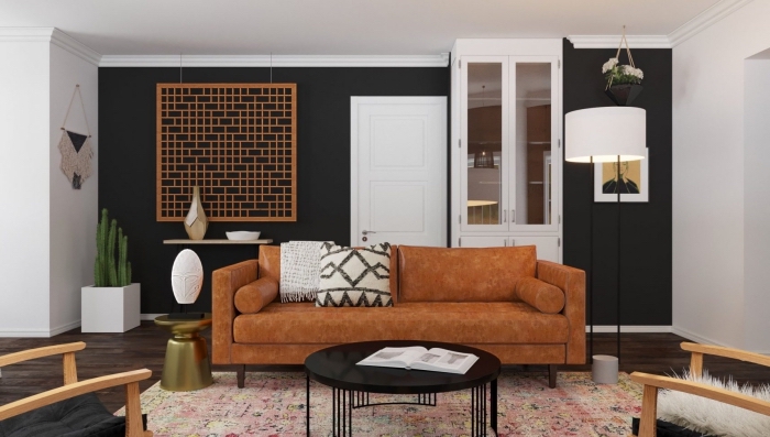 pièce blanche avec mur noir au parquet bois foncé, modèle de canapé tendance 2020 en tissu marron décoré avec coussins bohème chic