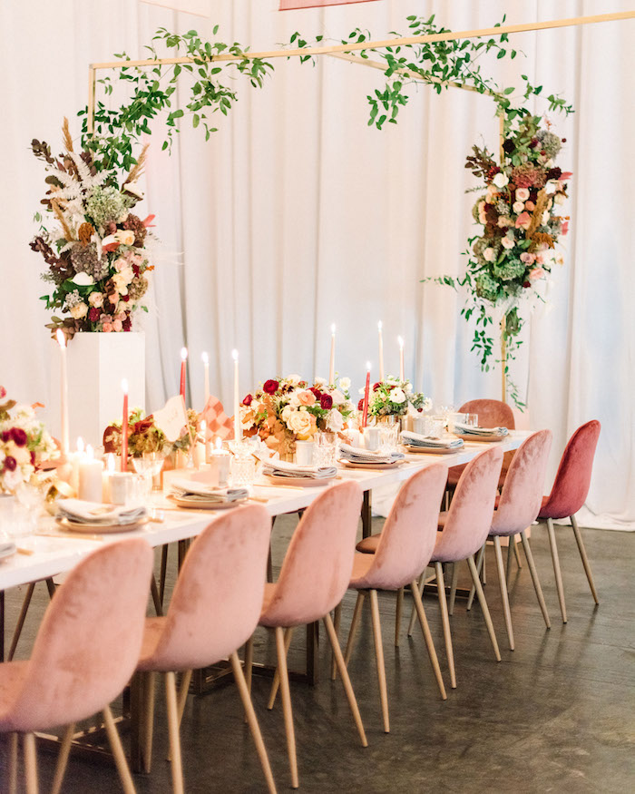chaises rose rangées autour d une table blanche, deco boheme chic mariage avec compositions florales riches, deco bougies decoratives