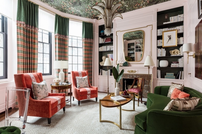 design intérieur tendance dans un salon rose pastel au plafond à motifs tropicaux aménagé avec canapé tendance 2020 en velours vert
