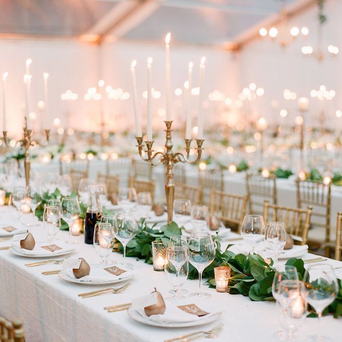 centre de table guirlande de feuillages verts et petites bougies, marque place mariage poire or, bougeoirs dorés