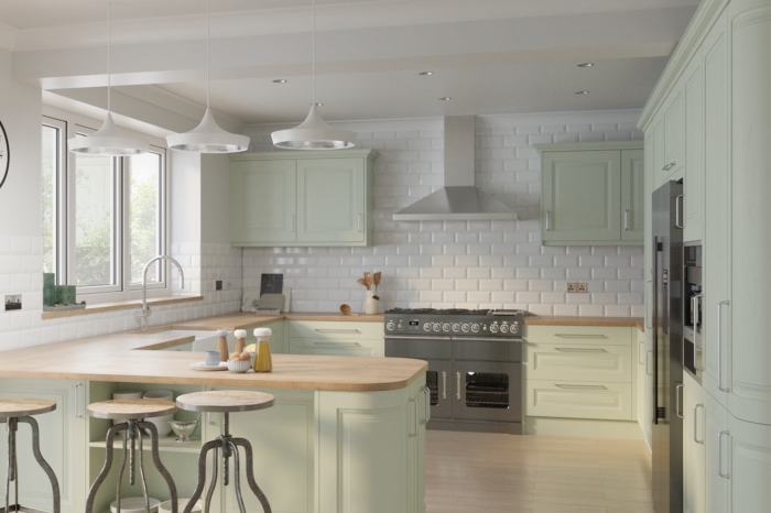 idée comment décorer une cuisine en U, modèle de cuisine aux murs en carreaux blancs avec comptoirs en bois et armoires vert pastel