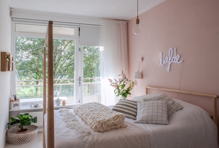 deco chambre fille aux murs rose pastel et plafond blanc aménagée avec meubles en bois et accessoires bohème