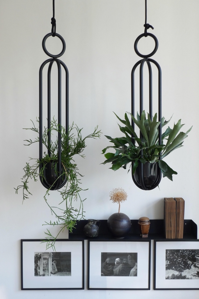 modèle de support pour plantes d'intérieur en métal, déco de pièce moderne aux murs blancs avec objets noirs