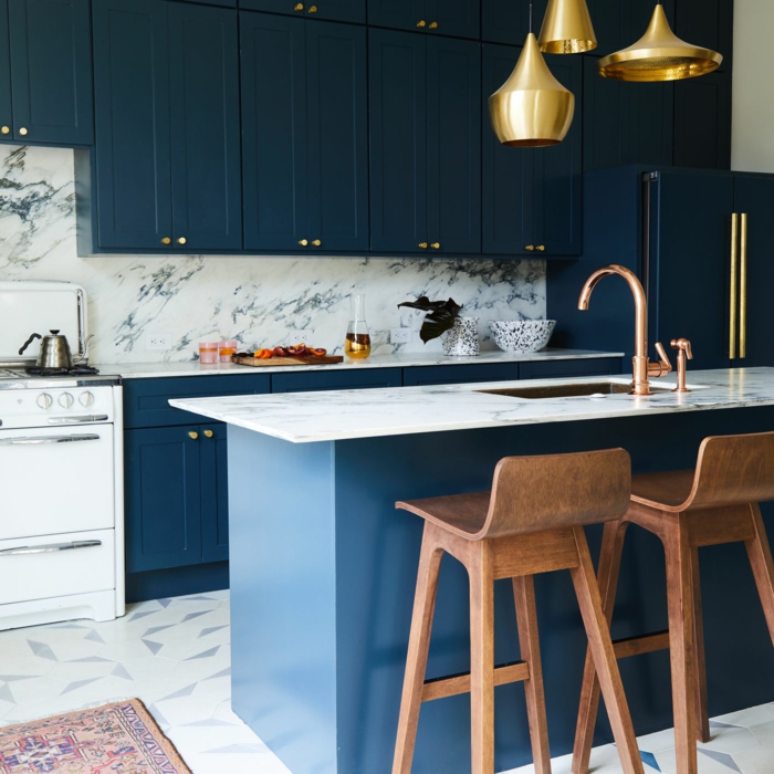 Lustres dorés en dessous de l'ilot en marbre, comment décorer une cuisine bleu nuit, idée couleur cuisine