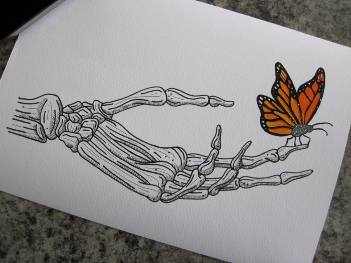Main de squelette et papillon sur le doigt comment dessiner un papillon, idée coloriage papillon beau motif