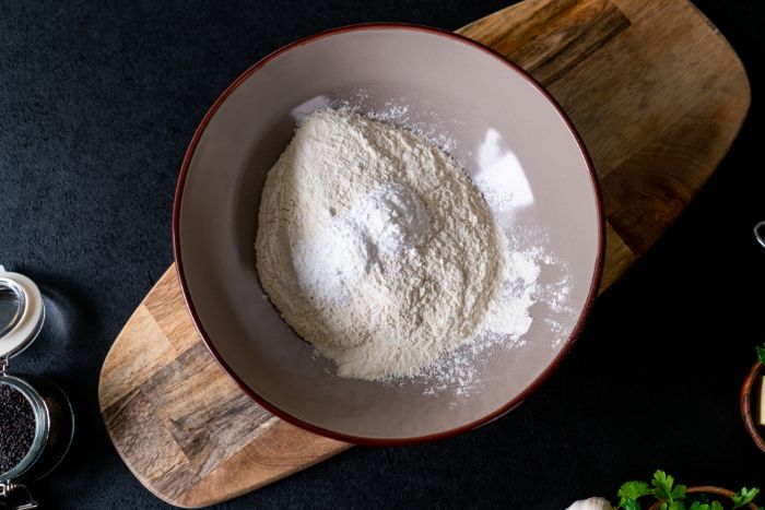 recette pour faire une galette indienne avec de la farine blanche dans un bol, naan maison sans machine