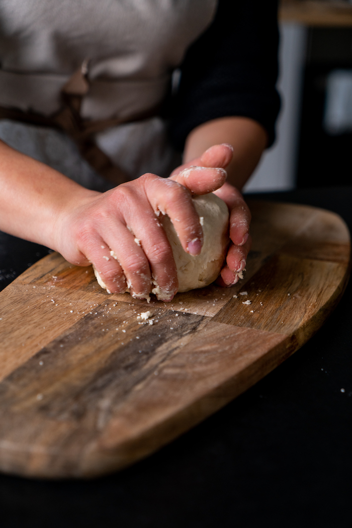 pétrir une pâte de ses mains pour faire recette naan, idée pain indien traditionnel a faire soi meme