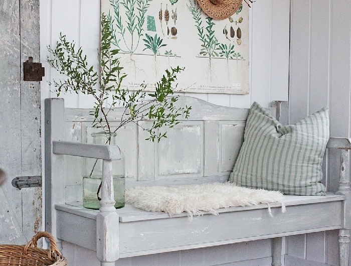 revêtement mural panneaux blancs banquette entrée style vintage panier tressé fibre végétale coussin décoratif vase verre housse fausse fourrure blanche