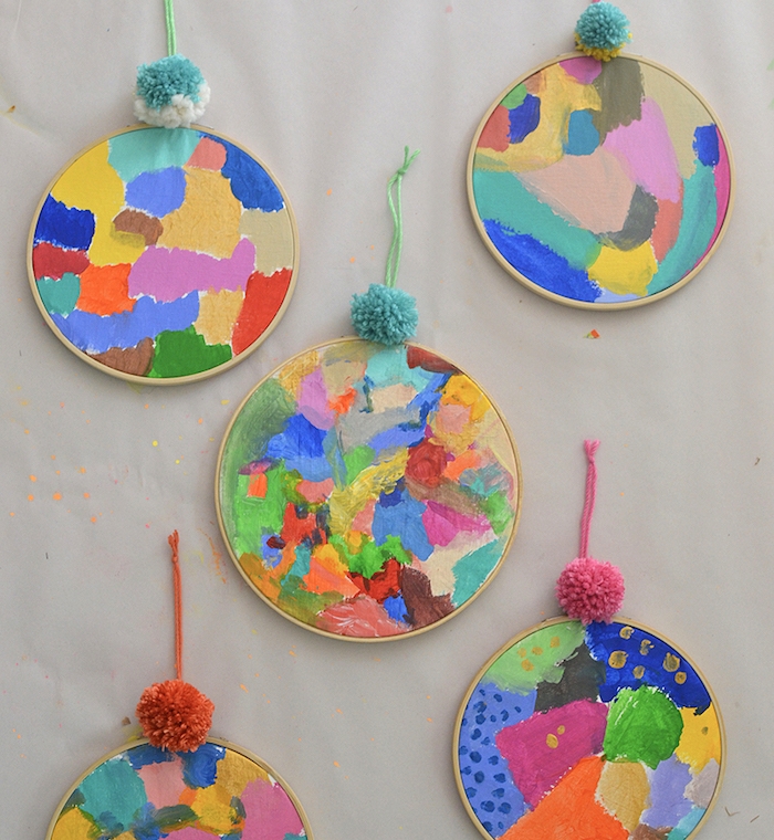 peinture abstraite idée activité peinture pour enfant avec des motifs abstraits taches de peinture sur tambour à broder avec décoration de pompon de laine