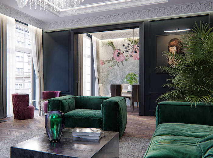 appartement deco parisienne avec canapé et fauteuil vert rubin tapis gris fauteuils bordeaux parquet chevron ouverture sur salle à manger design