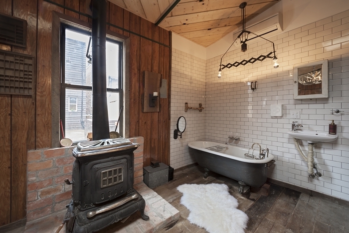baignoire gris et blanc autoportante chambre avec salle de bain ouverte carrelage métro tapis fausse fourrure blanche