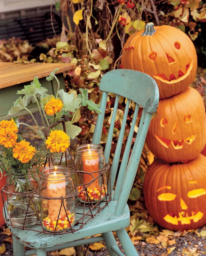 exemple de décoration halloween à fabriquer dans des bocaux en verre décorés de bonbons mais et bougie vase en pot et citrouilles jack o lantern superposées