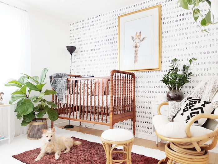 inspiration déco chambre bébé cocooning lit vintage bois mur tapissée de papier peint noir et blanc plantes vertes tabouret et fauteuil bambou
