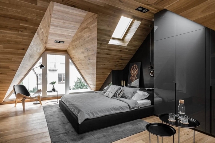 panneaux bois mur revêtement chambre avec dressing noir moderne sans poignée cadre de lit cuir noir tapis gris anthracite