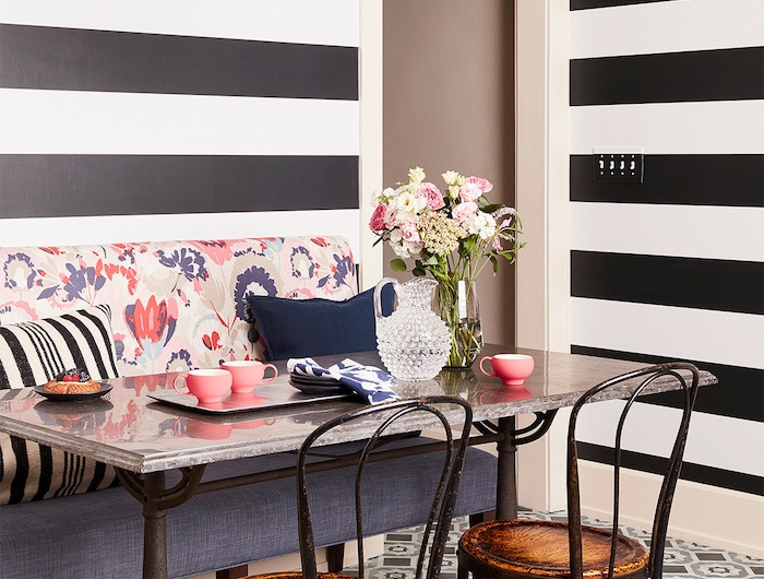 petit coin repas de cuisine avec un canape et deux chaises combinaison et contraste des motifs au sol et aux murs