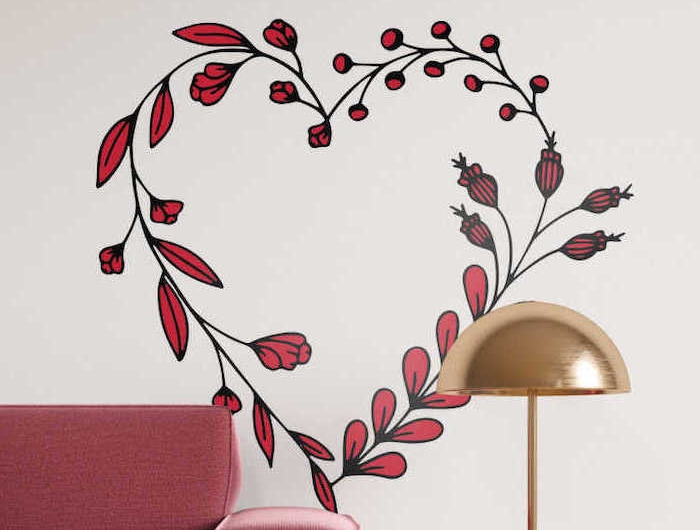 sticker mural en forme de coeur avec des feuilles au dessus d un canape rouge et une lampe doree