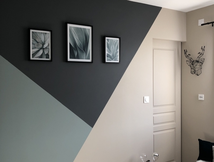 déco chambre moderne mur bicolore motifs géométriques peinture mur triangle table café bois et métal cadres photos noirs
