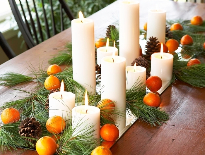 oranges pommes de pin centre de table noel a faire soi meme bougies blanches branches arbre de noel vertes