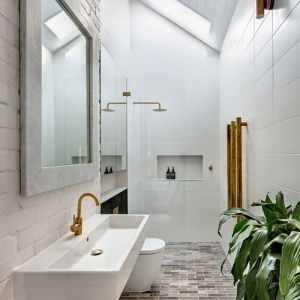 salle de bain moderne petit espace carrelage blanc fenêtre toit mur briques blanches miroir plantes vertes intérieur