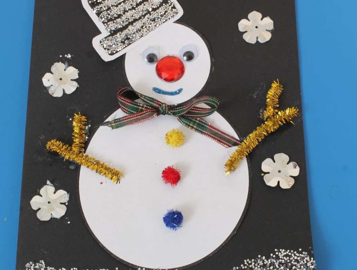 bricolage noel maternelle facile carte dans papier noir avec bonhomme de neige papier blanc pompons colorés des yeux mobiles