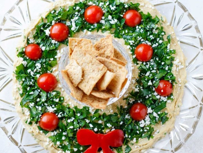 couronne de noel houmous au persil et tomates cerises servi avec des crackers repas de noel original à partager entre amis