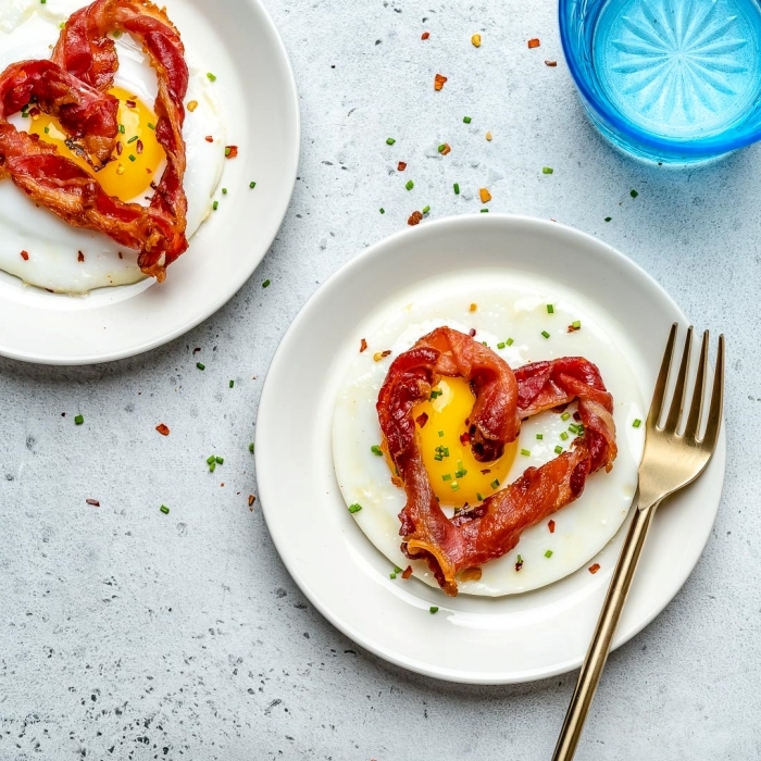 bacon rôti en forme de coeurs image petit déjeuner oeuf assiette blanche ronde repas romantique