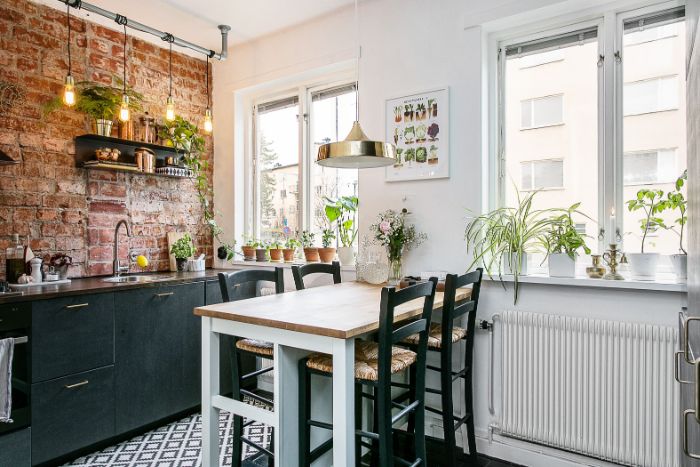 crédence mur de briques meuble cuisine gris anthracite ilot table bois et chaises bistrot murs blancs plantes vertes cuisine d appartement