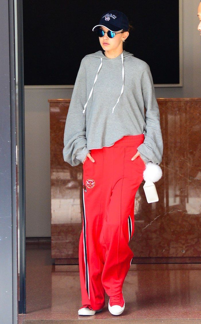 gigi hadid dressed in women's streetwear outfit with sunglasses and sporty cap