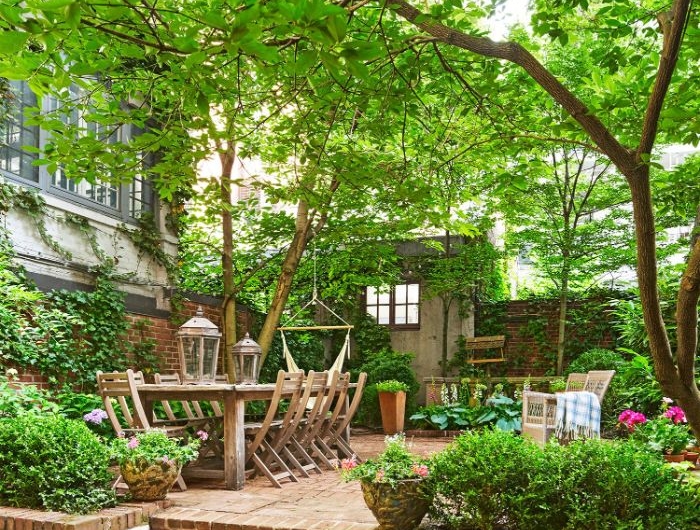 jardinage et aménagement paysager exemple de terrasse avec mobilier de jardin bois brut végétation florissante bordures de jardin plantes exterieures en pot