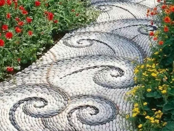 massif de fleurs avec des pierres en spirale qui forme une alle